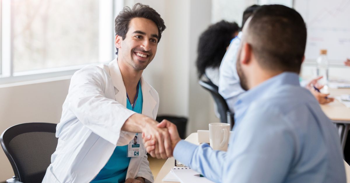 Doctors shaking hands and networking